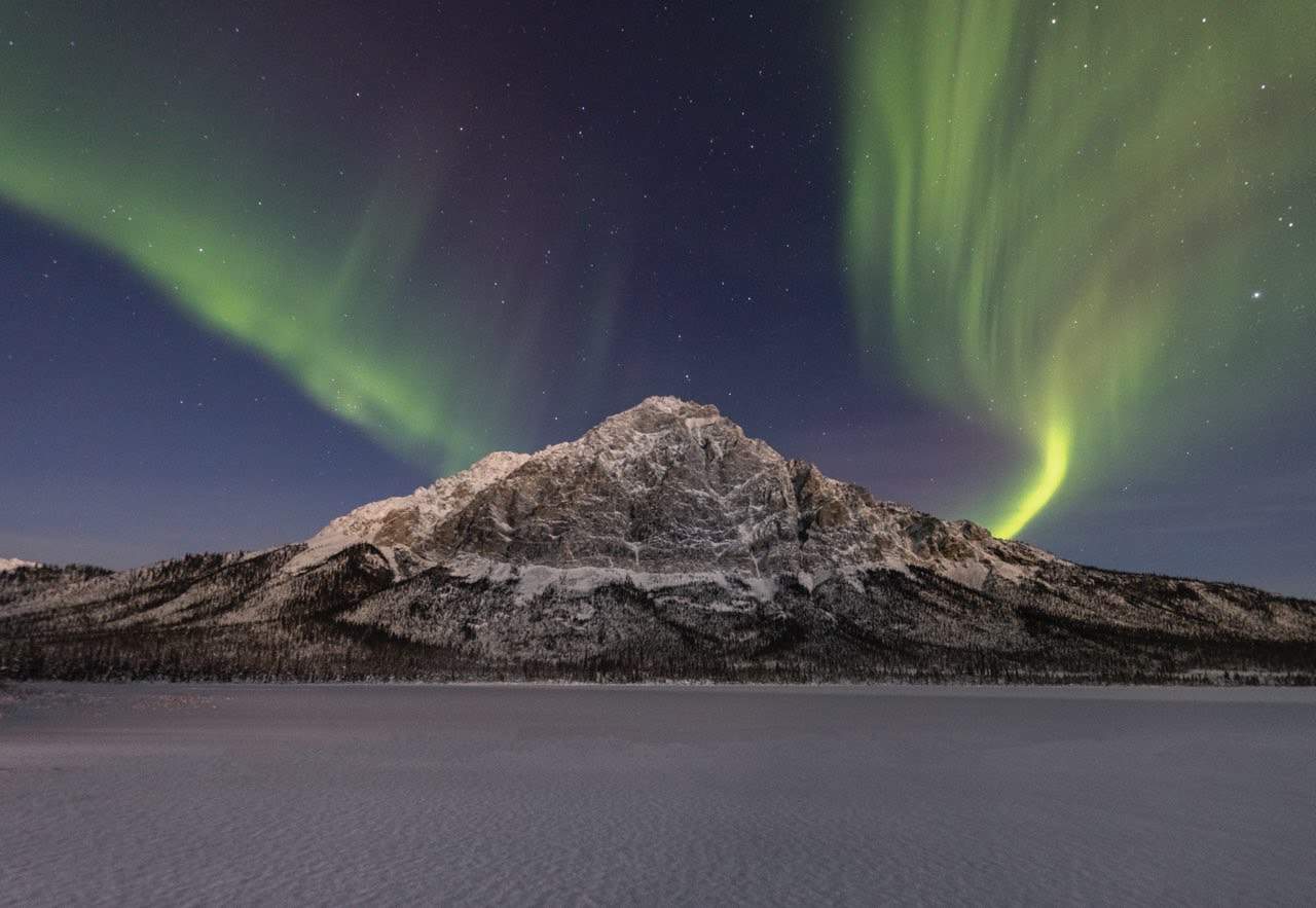 Northern lights over a peak in Alaska